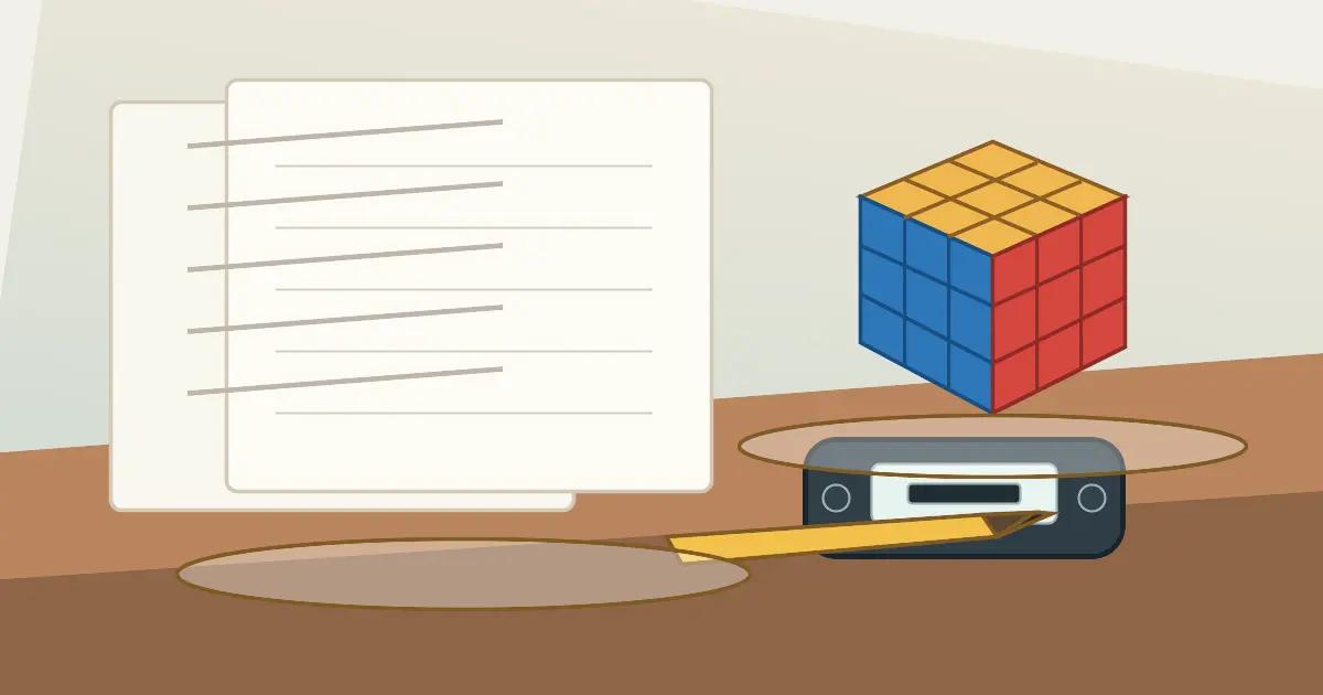 A Fewest Moves competition desk with a 3x3 cube, pencil, timer, and solution sheets.